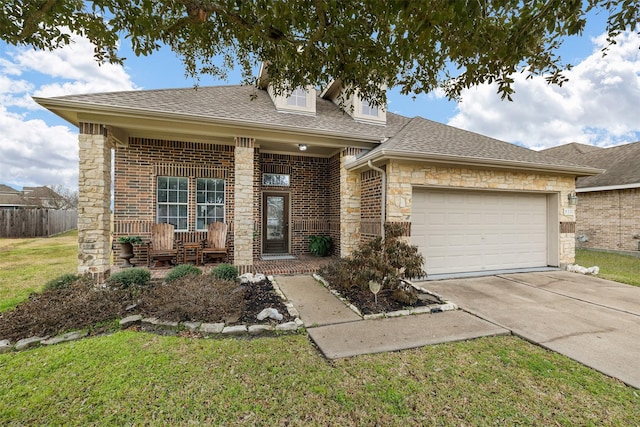 view of front of house featuring a garage and a front lawn