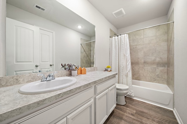 full bathroom featuring vanity, hardwood / wood-style flooring, shower / bath combination with curtain, and toilet