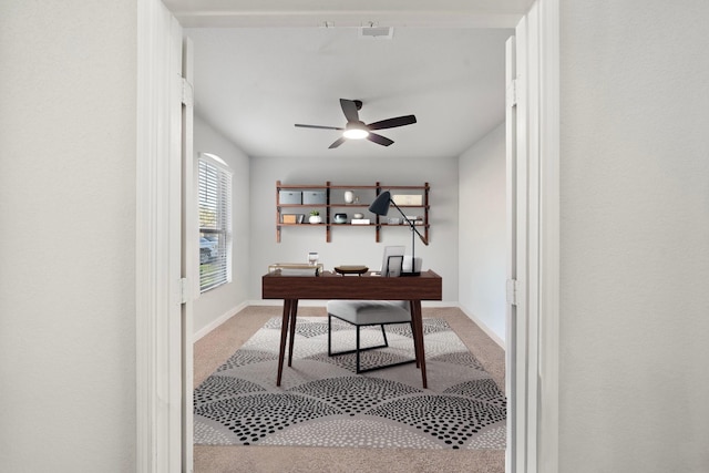 office space with light colored carpet and ceiling fan