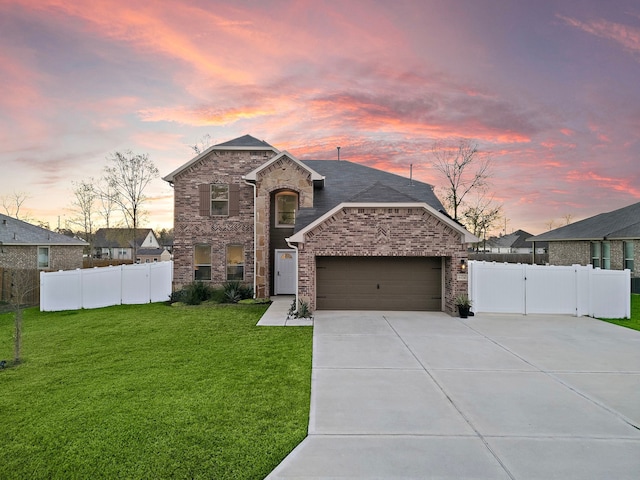 view of front facade with a yard and a garage