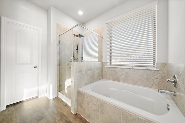 bathroom featuring hardwood / wood-style flooring and shower with separate bathtub