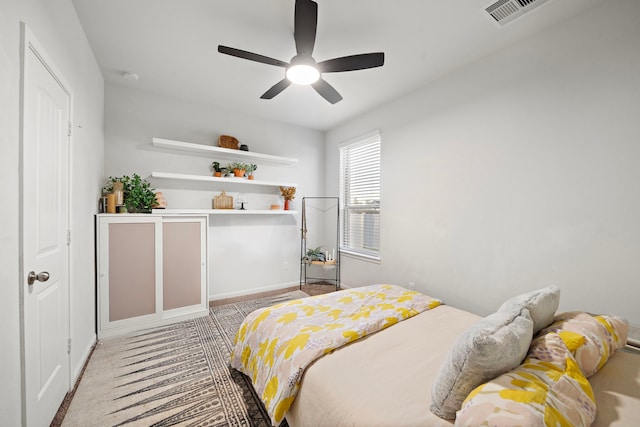 bedroom featuring light carpet and ceiling fan