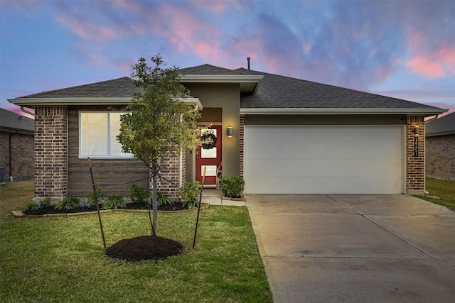 view of front facade with a lawn and a garage