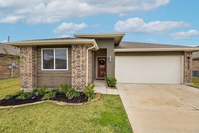 view of front of property featuring a garage and a front lawn