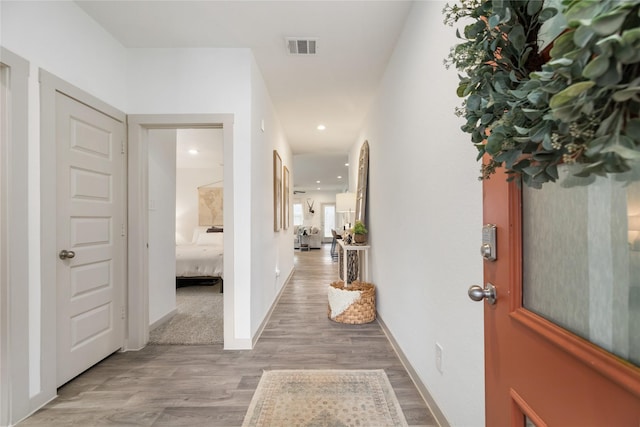 corridor with light hardwood / wood-style flooring