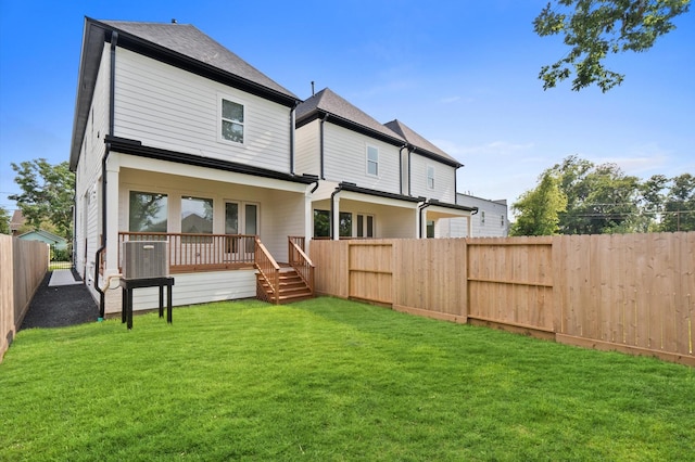 back of house with a lawn and a wooden deck