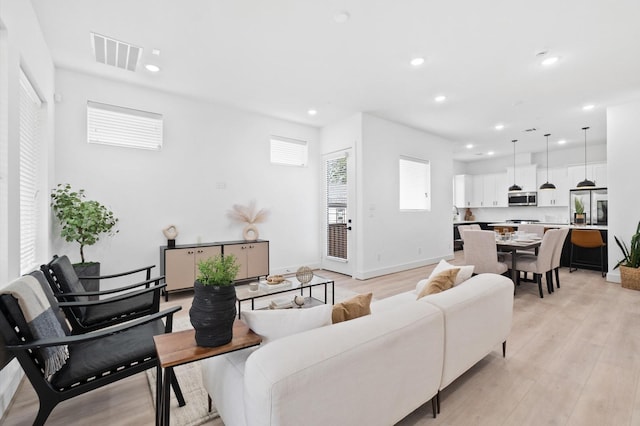 living room with light hardwood / wood-style flooring