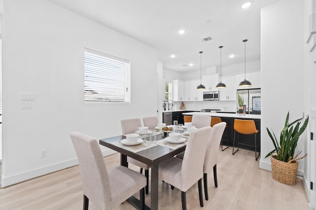 dining space featuring light wood-type flooring