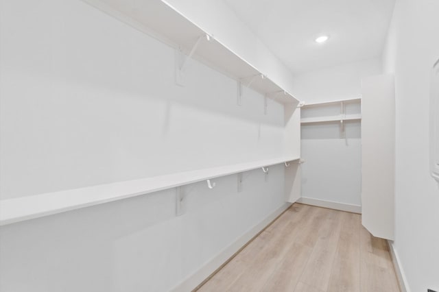 walk in closet featuring light hardwood / wood-style flooring