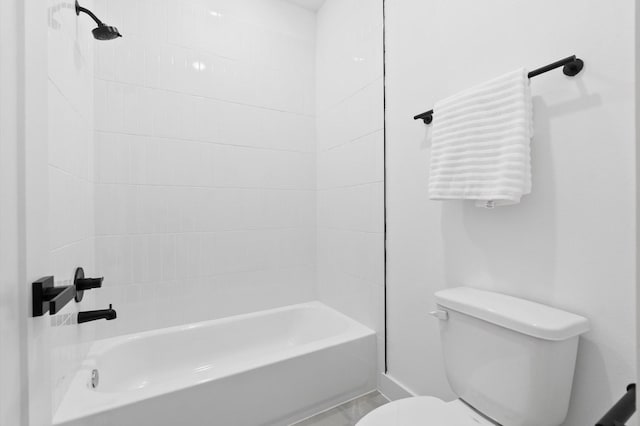 bathroom featuring shower / bathing tub combination and toilet