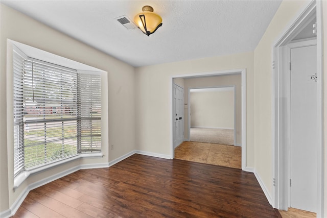 spare room featuring dark wood-type flooring