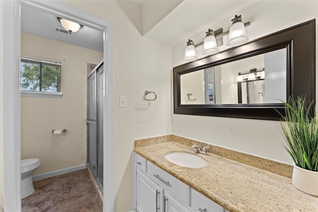 bathroom with vanity, an enclosed shower, and toilet