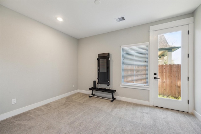 unfurnished living room with light colored carpet