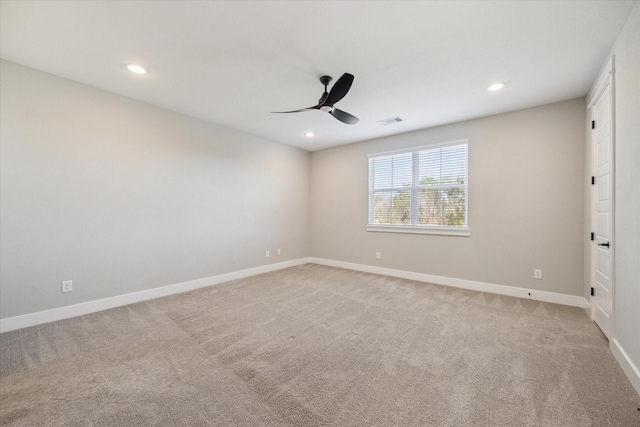 carpeted spare room with ceiling fan