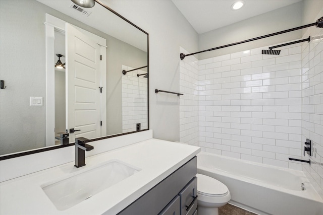 full bathroom featuring vanity, toilet, and tiled shower / bath combo