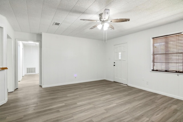 empty room with hardwood / wood-style flooring and ceiling fan