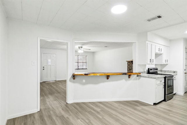 kitchen with electric range, white cabinets, light wood-type flooring, and ceiling fan