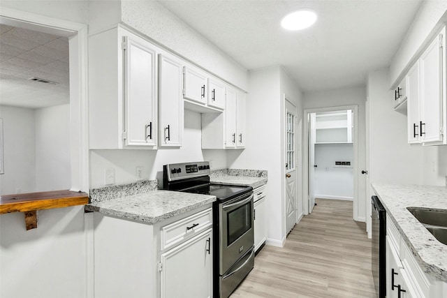 kitchen featuring white cabinetry, stainless steel electric range oven, and light stone countertops