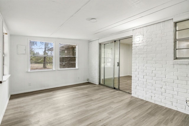 unfurnished room with light wood-type flooring