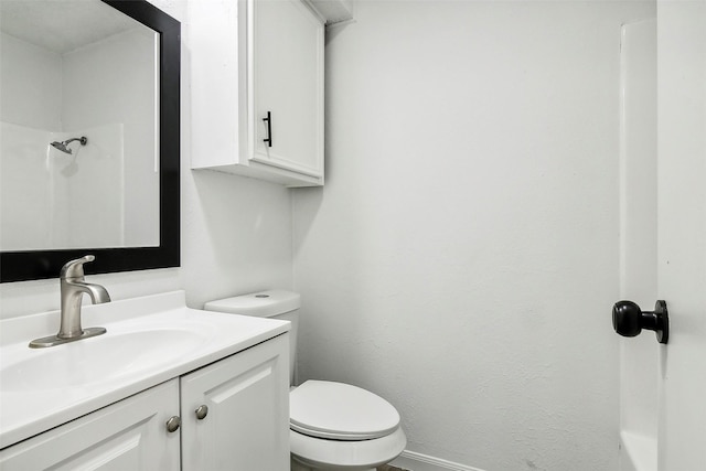 bathroom with vanity, toilet, and walk in shower