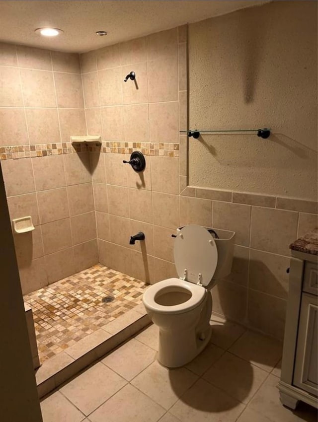 bathroom featuring walk in shower, tile patterned floors, and tile walls