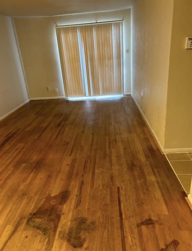 spare room featuring dark wood-type flooring