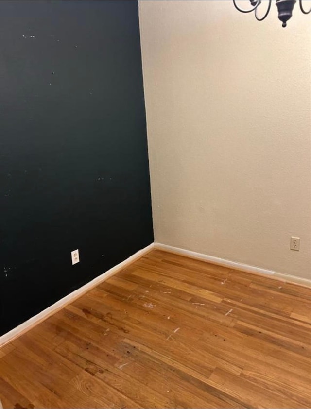 spare room featuring wood-type flooring