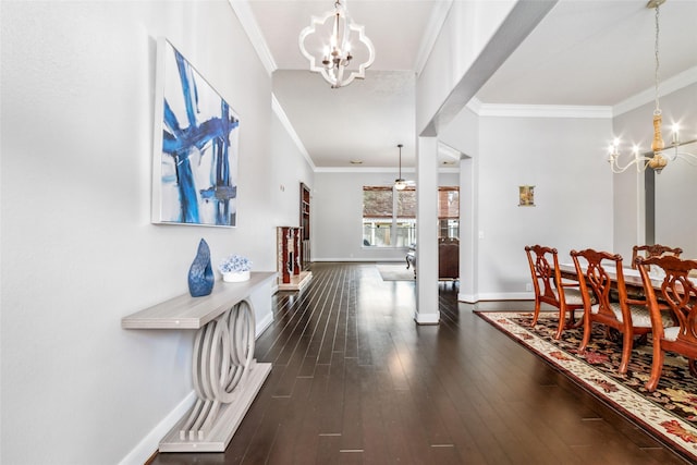 interior space with dark wood-type flooring, ornamental molding, and an inviting chandelier