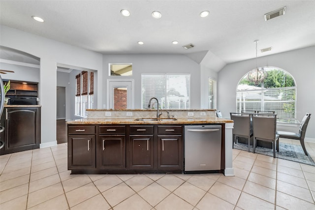 kitchen with pendant lighting, sink, stainless steel dishwasher, dark brown cabinets, and a healthy amount of sunlight