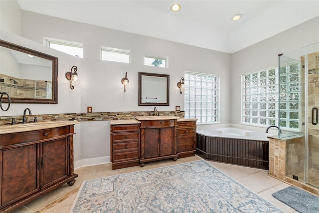 bathroom featuring tile patterned flooring, vanity, and shower with separate bathtub