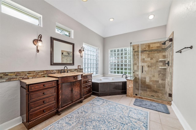 bathroom with tile patterned floors, vanity, a healthy amount of sunlight, and separate shower and tub