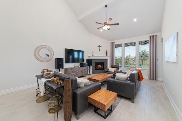 living room with ceiling fan and high vaulted ceiling