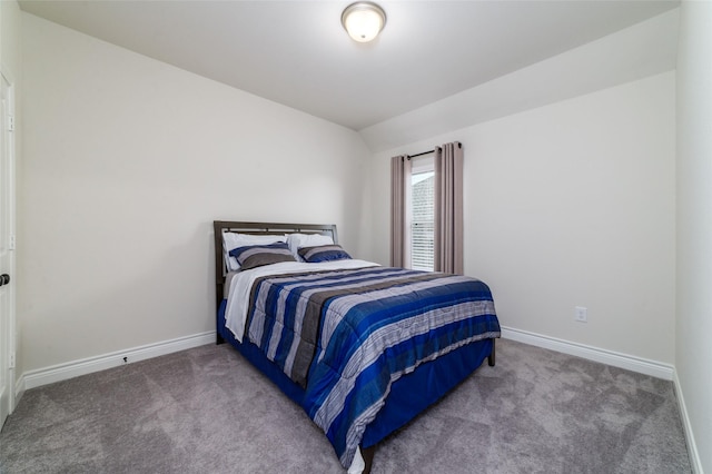 bedroom with carpet flooring and vaulted ceiling