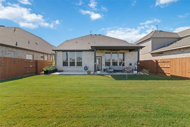 rear view of property featuring a lawn, ceiling fan, and a patio area