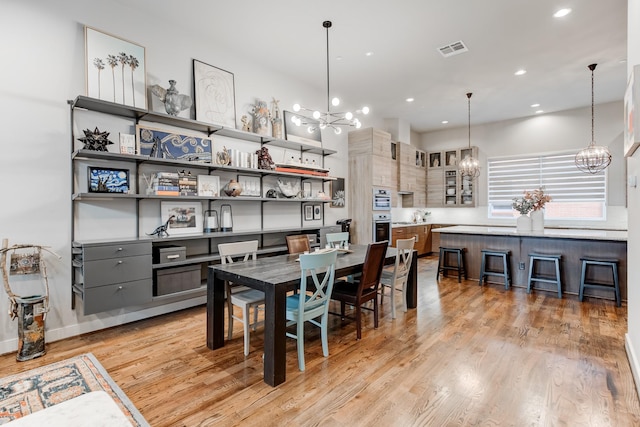 dining space with light hardwood / wood-style flooring