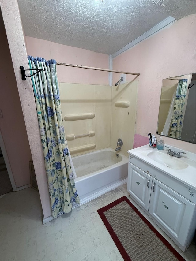 bathroom with shower / bath combo, a textured ceiling, and vanity