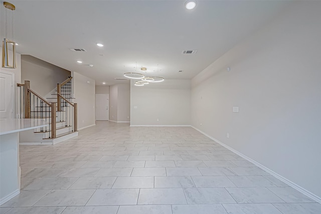 unfurnished room featuring light tile patterned floors and an inviting chandelier