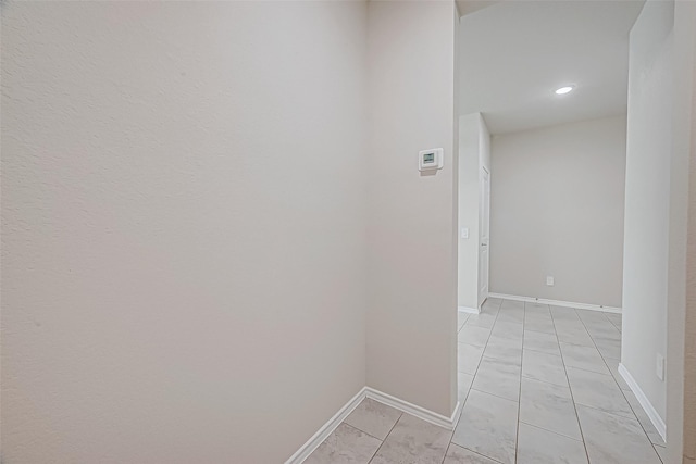 hall featuring light tile patterned floors