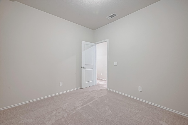 empty room with light colored carpet