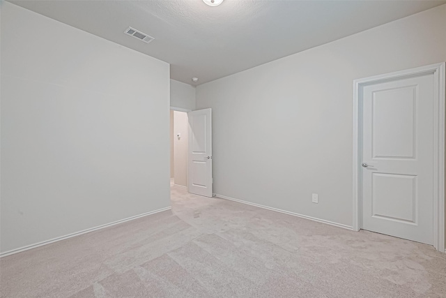 empty room with light colored carpet