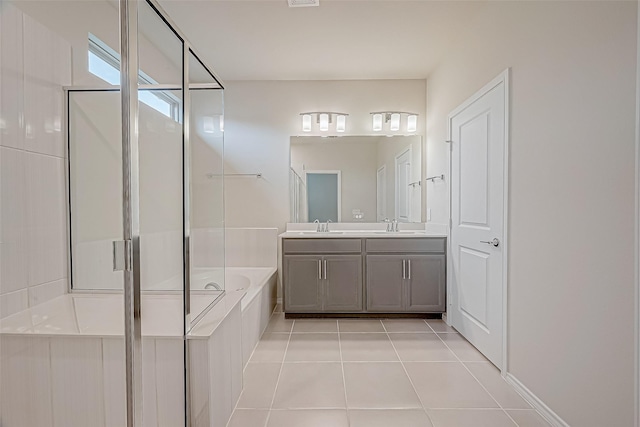 bathroom with tile patterned floors, vanity, and shower with separate bathtub