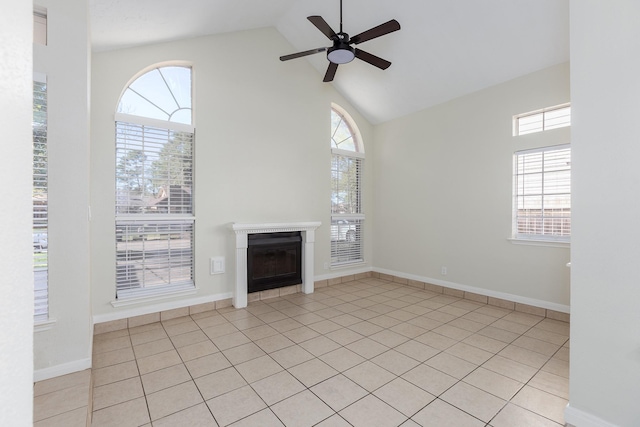 unfurnished living room with ceiling fan, light tile patterned floors, and a wealth of natural light