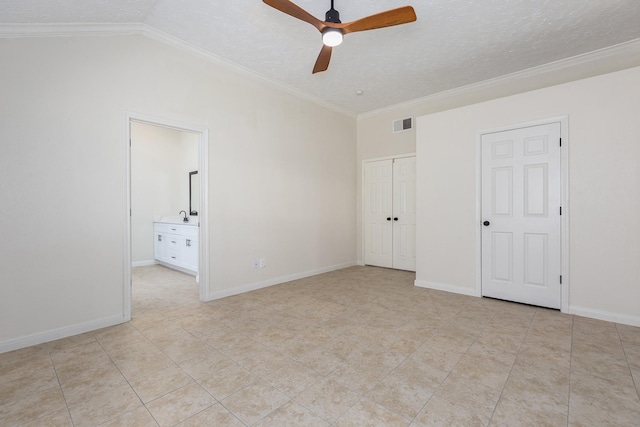 unfurnished bedroom featuring connected bathroom, ceiling fan, a textured ceiling, vaulted ceiling, and ornamental molding