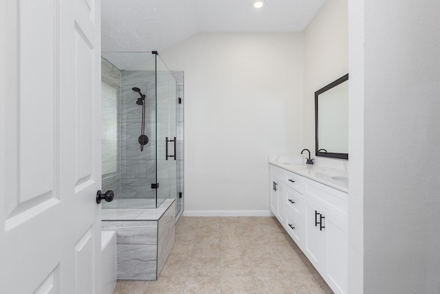 bathroom featuring a shower with door, vanity, a textured ceiling, and tile patterned flooring