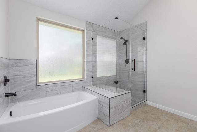 bathroom with tile patterned floors, a textured ceiling, shower with separate bathtub, and vaulted ceiling