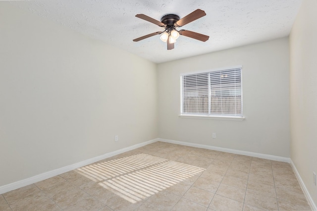 unfurnished room featuring ceiling fan, light tile patterned floors, and a textured ceiling