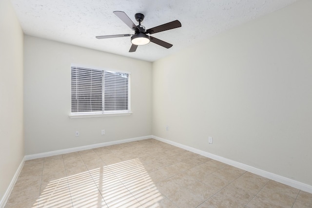 tiled spare room featuring a textured ceiling and ceiling fan