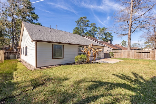 back of house with central AC, a yard, and a patio