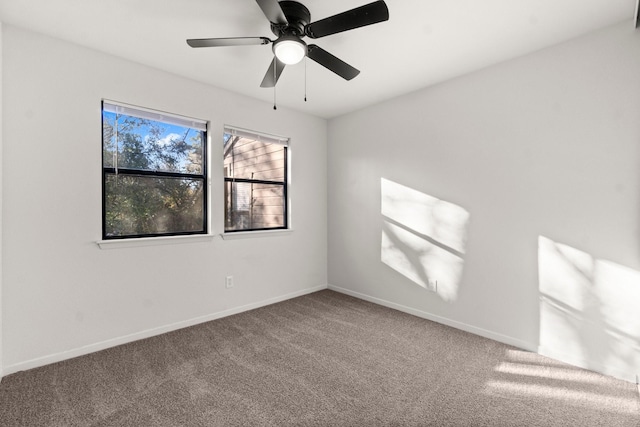 carpeted spare room with ceiling fan