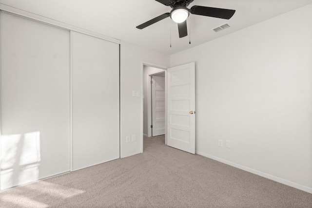 unfurnished bedroom featuring carpet flooring, a closet, and ceiling fan